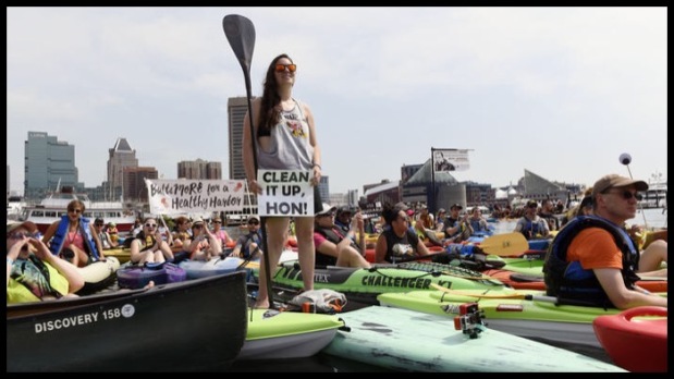 Paddle boarder rallying for clean water at the Baltimore Floatilla