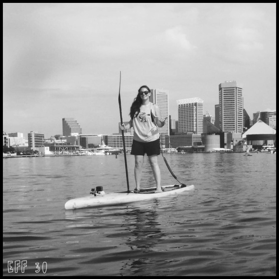Paddle Boarder with Baltimore skyline in the background